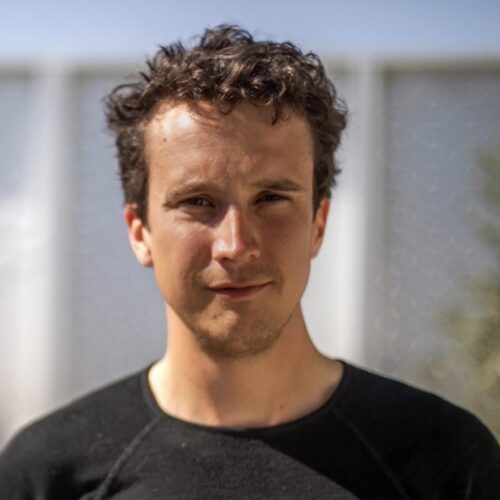 Headshot of Alex Darr standing outside.