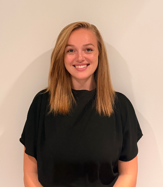 Headshot of Ashley Wakeling standing in front of a wall.